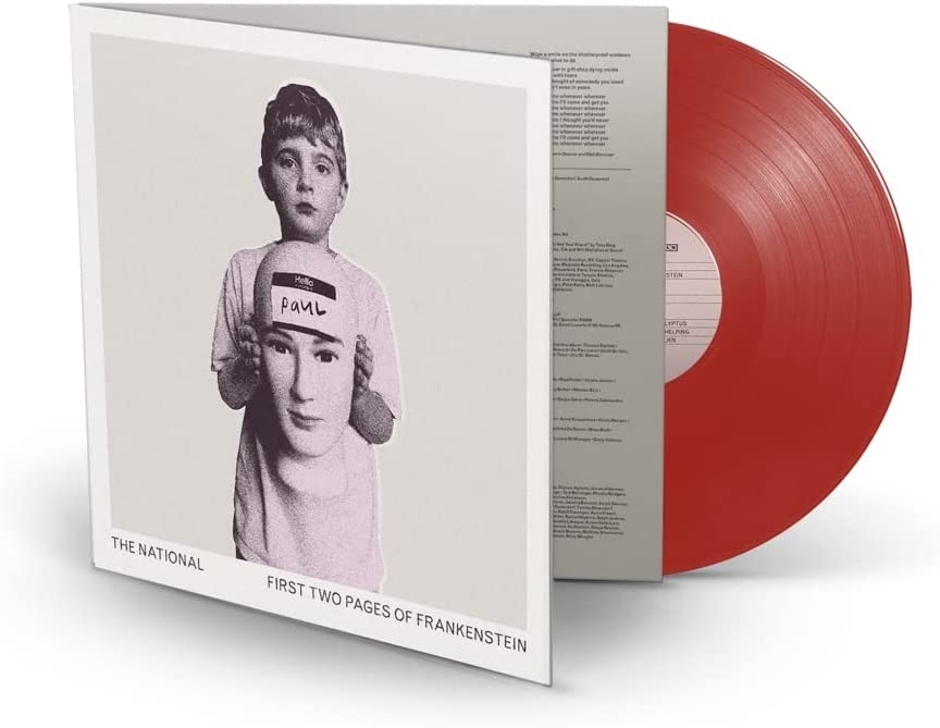 Red vinyl record with white sleeve featuring a black-and-white image of a child.