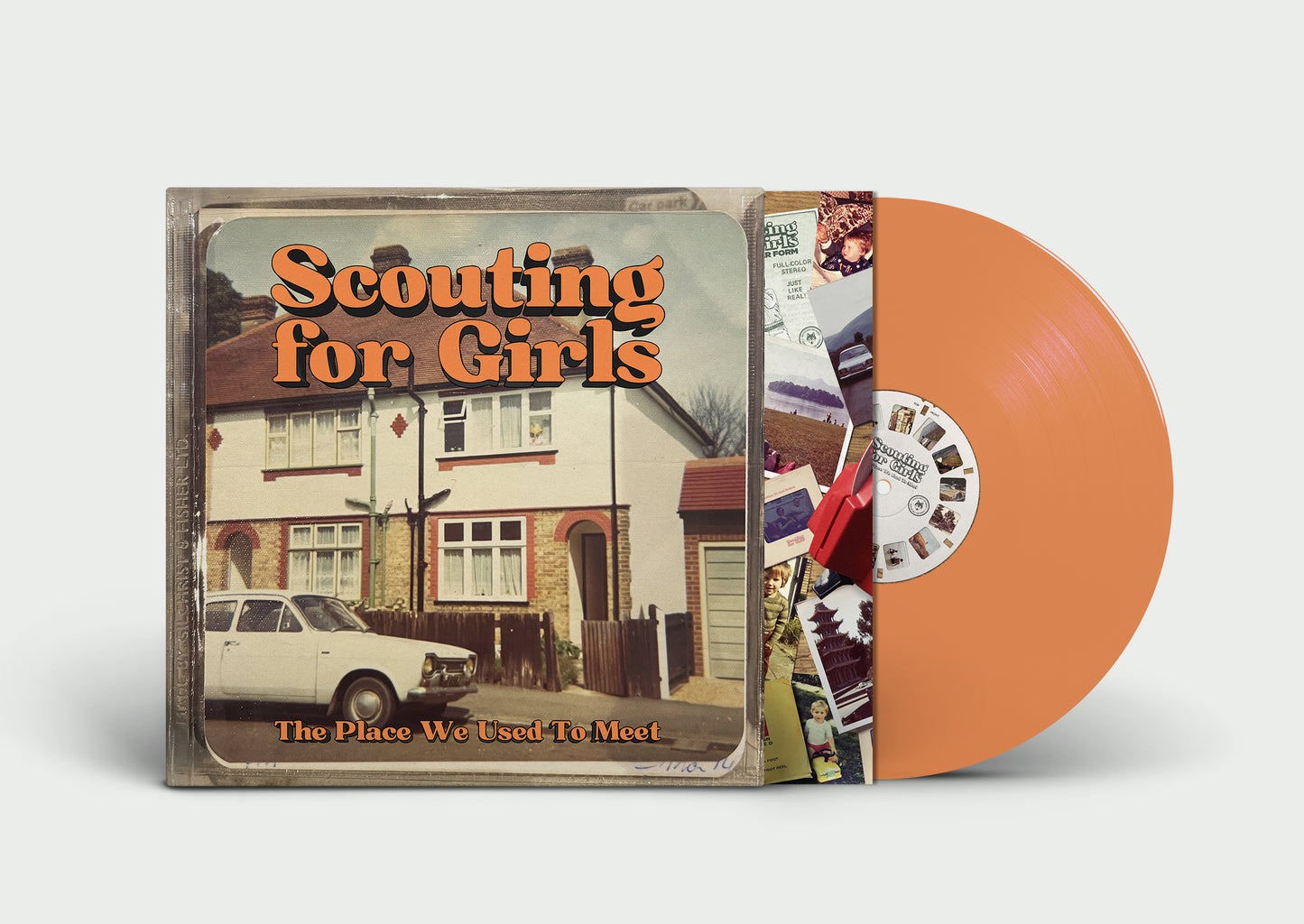 "Orange vinyl record and album cover with house image and text."