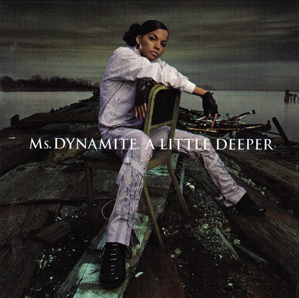 Ms. Dynamite album cover: artist seated on a weathered dock.