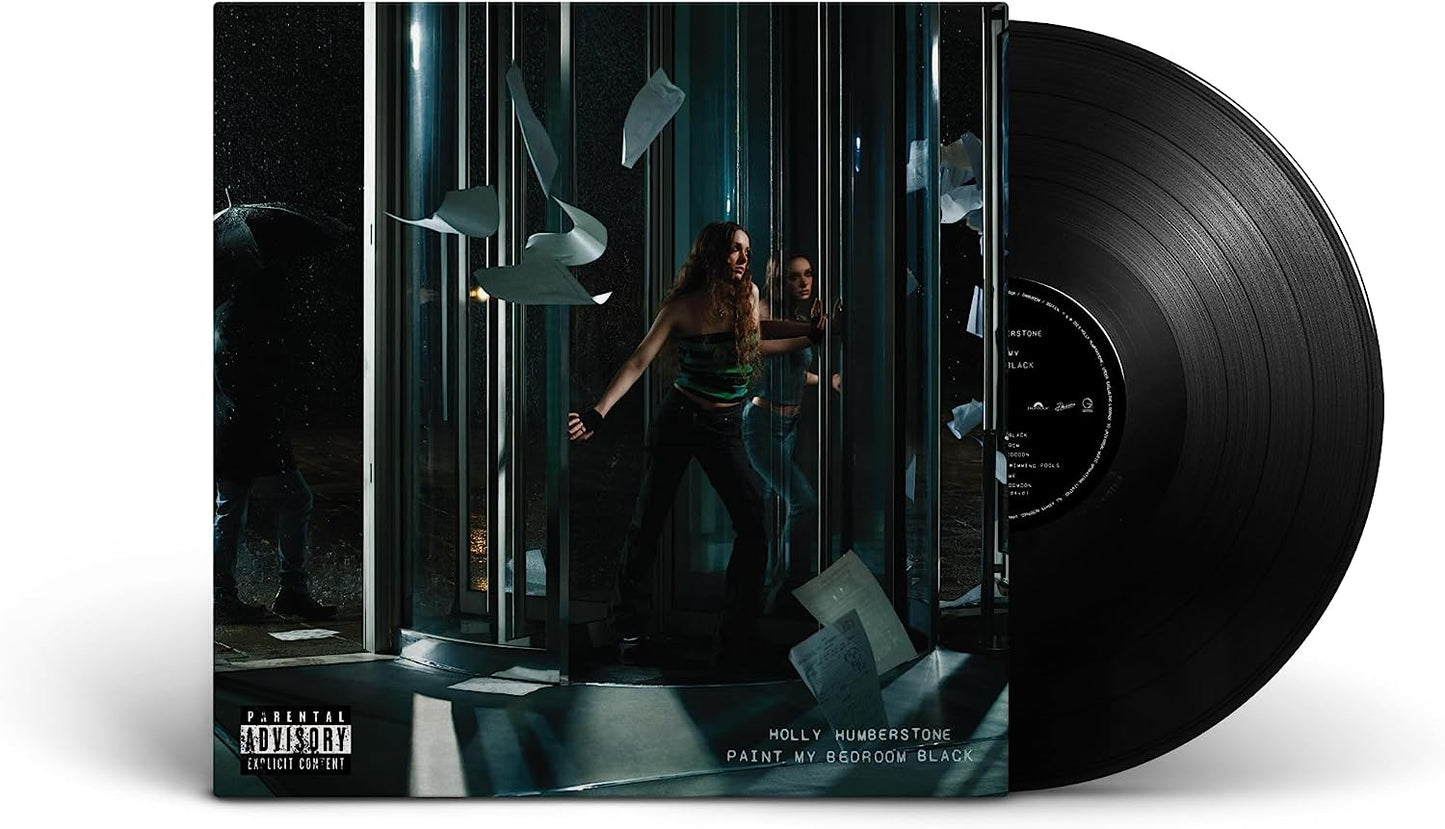 "Black vinyl record with album cover featuring a woman in a dark, mirrored room."