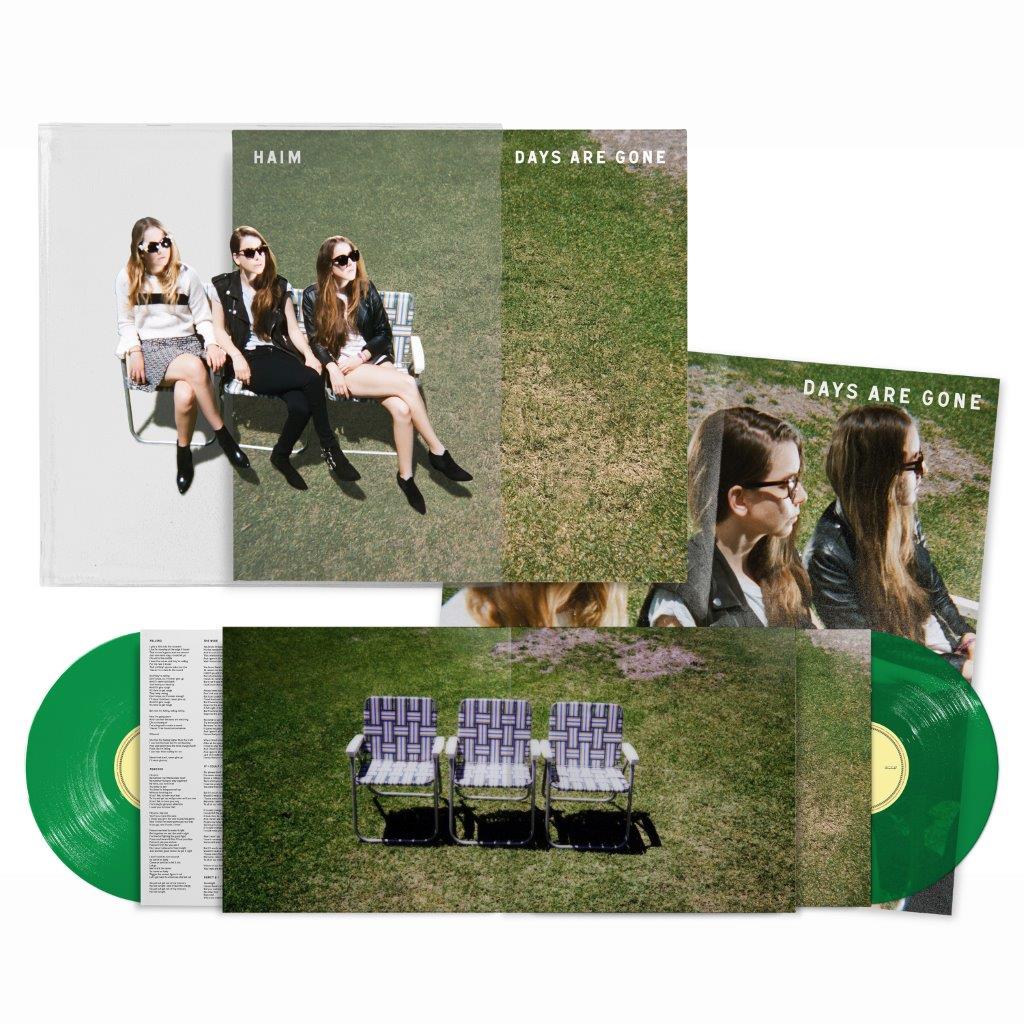 "Green vinyl records with album cover featuring three women sitting on lawn chairs."