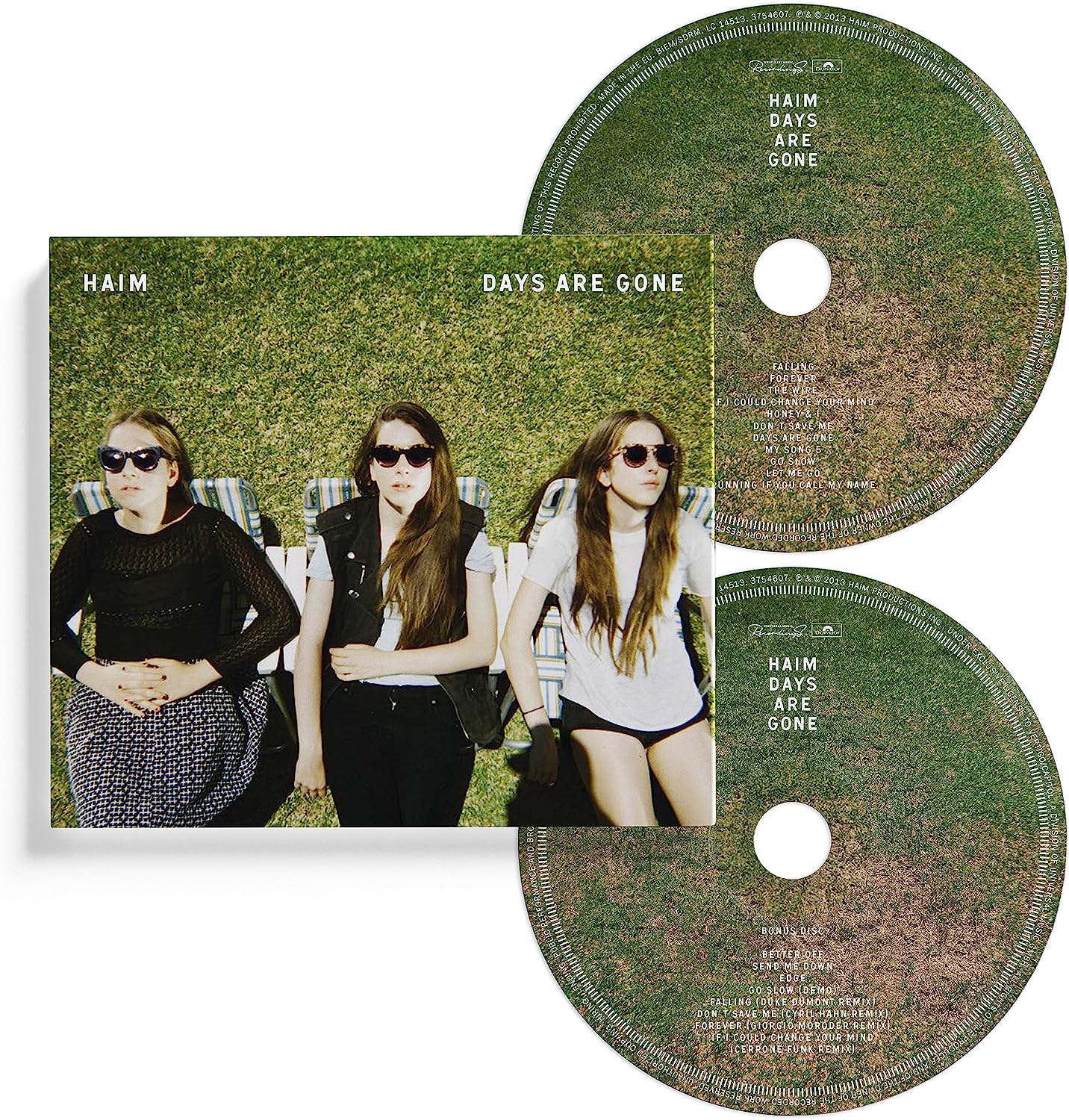 "CD case with two discs, featuring three women on a grassy background."