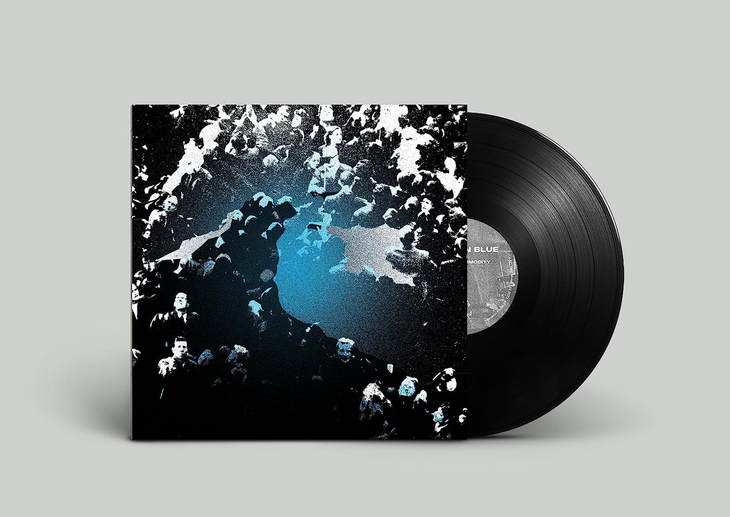 Black vinyl record with abstract cover art featuring blue and white shapes.