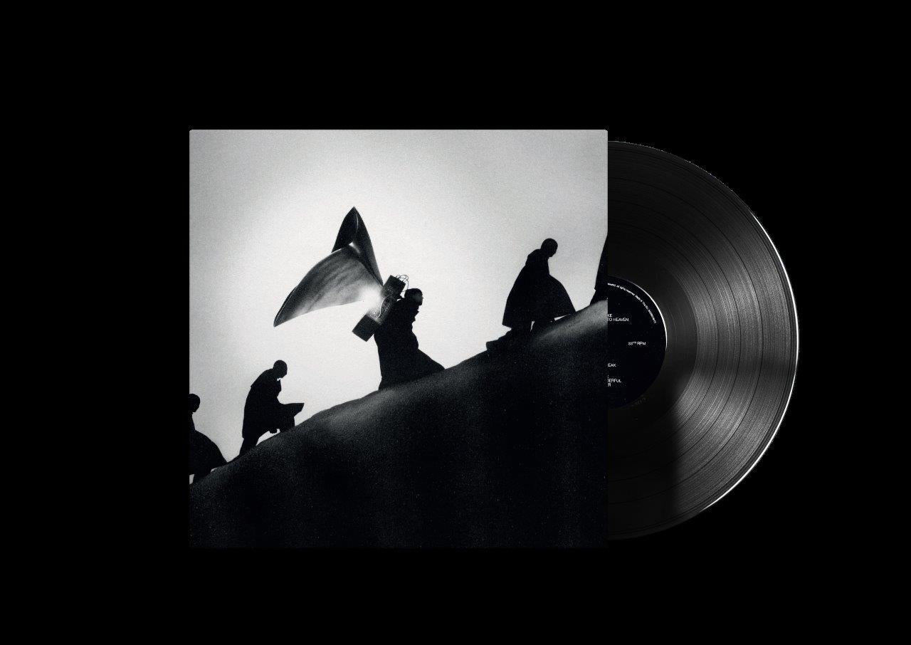 "Vinyl record with cover art featuring silhouetted figures on a hill against a white background."