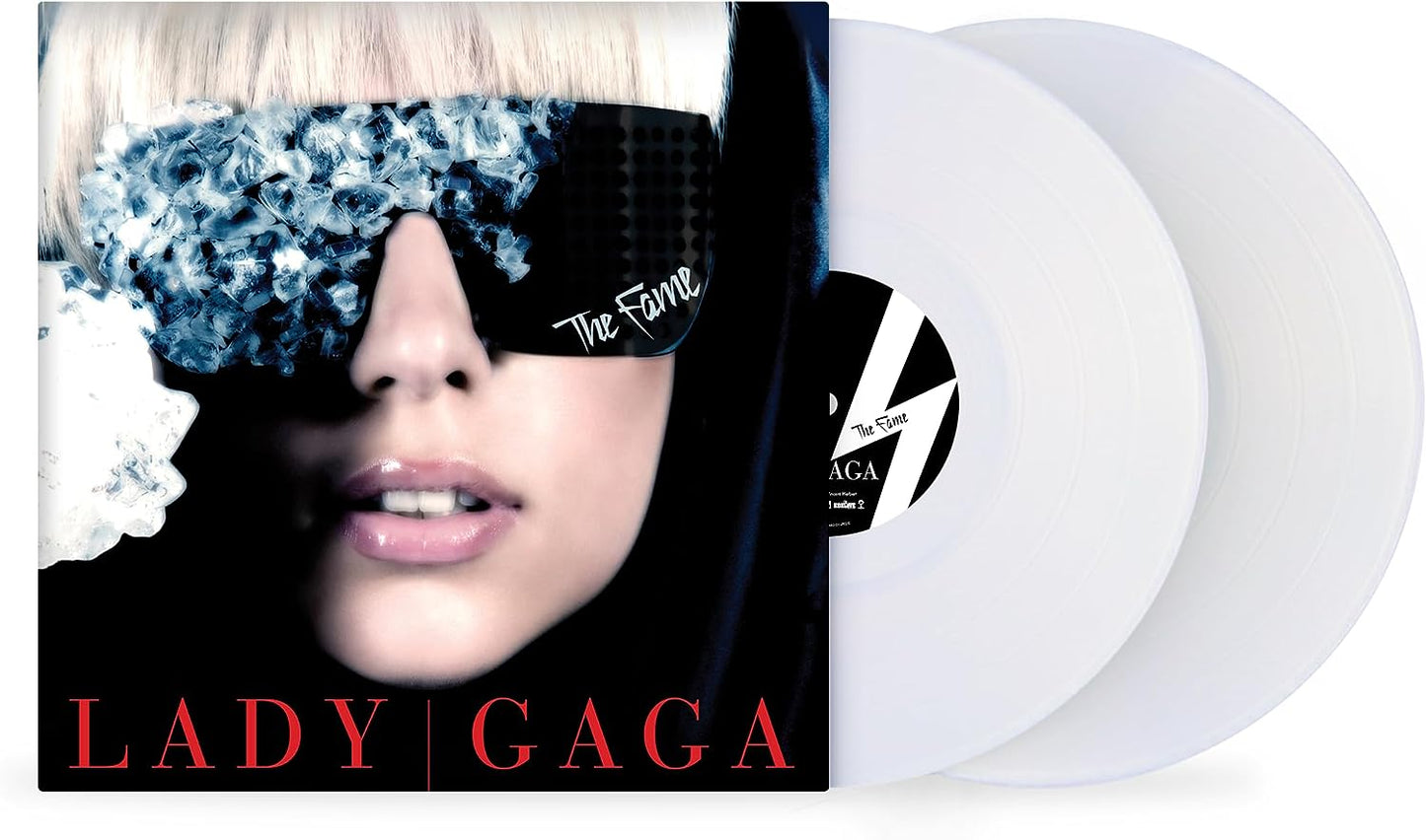 "White vinyl records with Lady Gaga album cover featuring a woman's face."