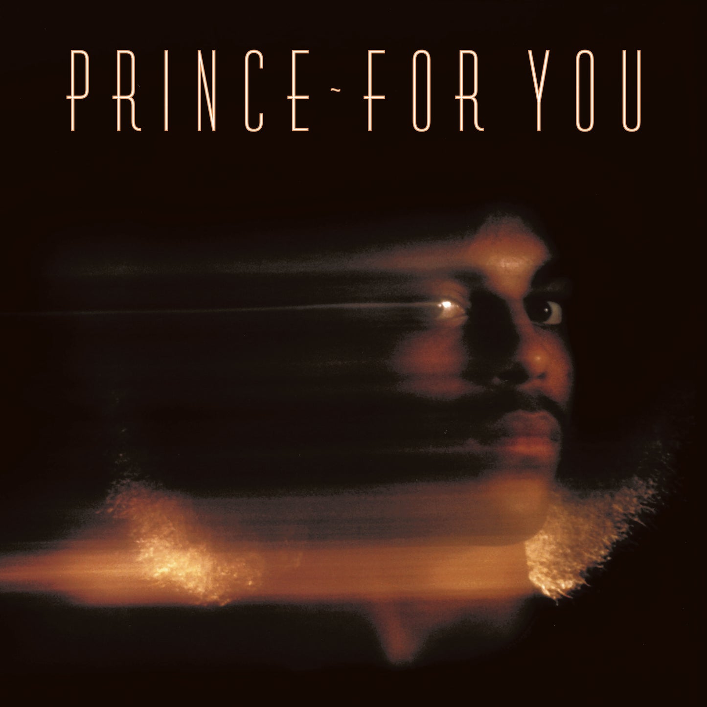 Prince's face is visible on a dark background with orange glow and text.