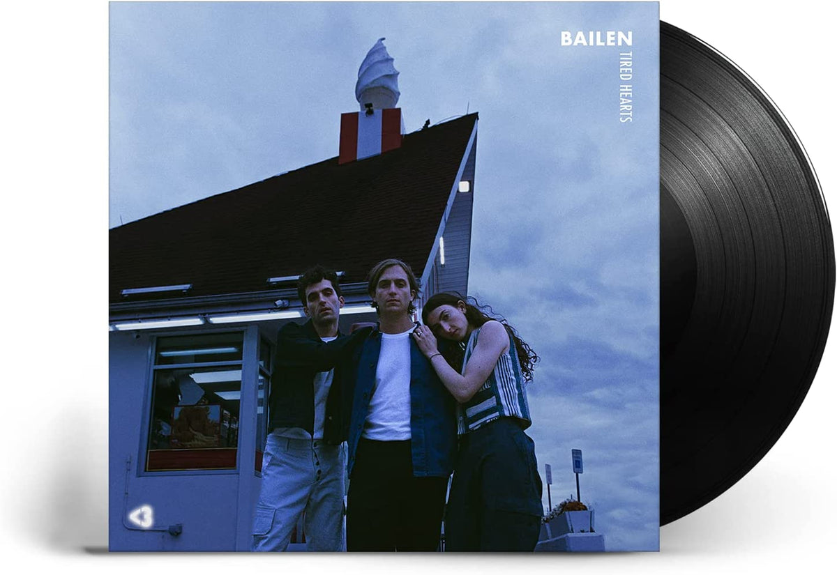 Vinyl record with cover art depicting three people and a pink diner.
