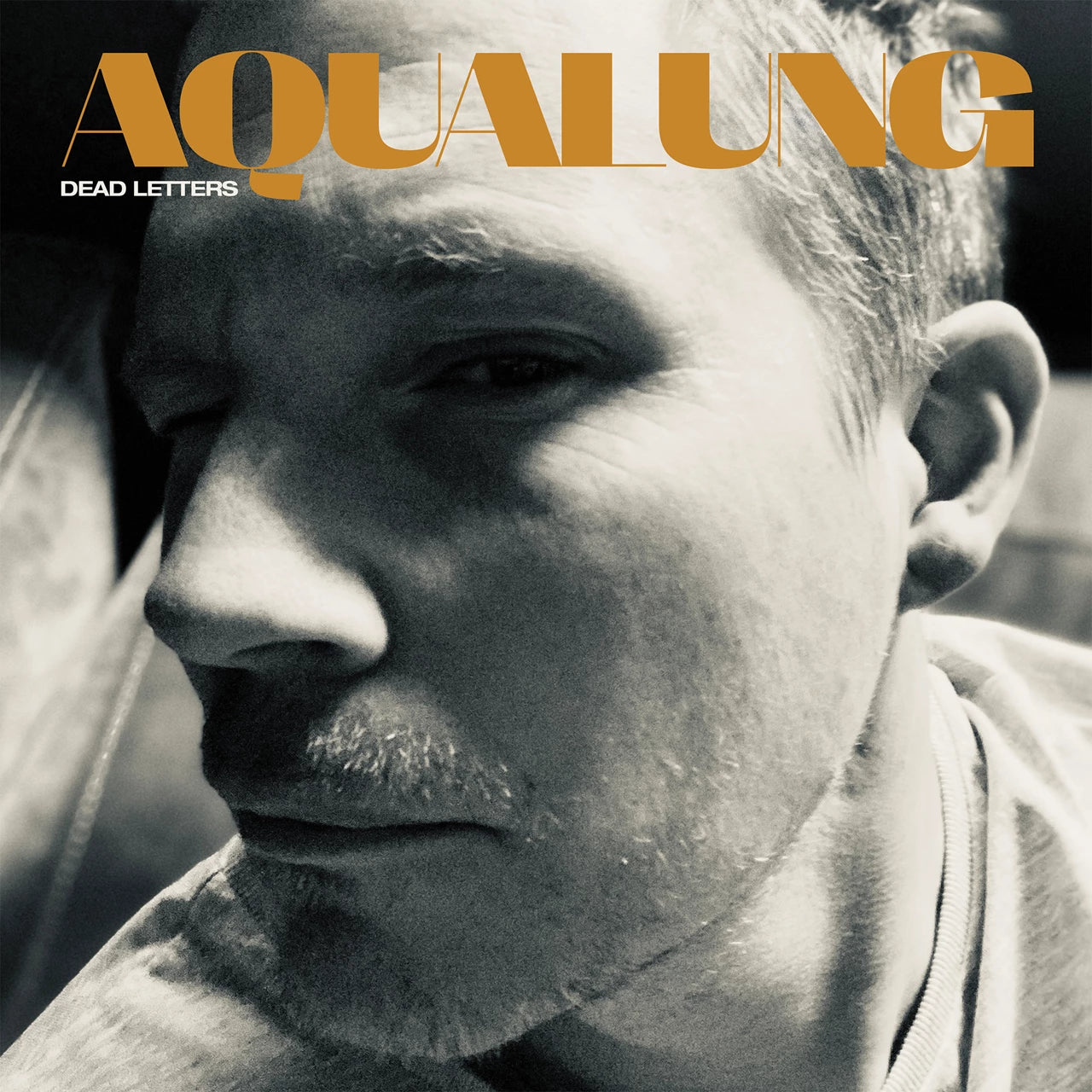 Aqualung “Dead Letters” album cover: close-up of a man’s face in grayscale.