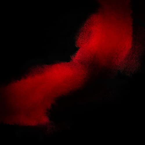 Abstract red powder explosion against a black background.
