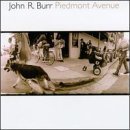 "CD cover featuring sepia-toned image of a dog on a city street."