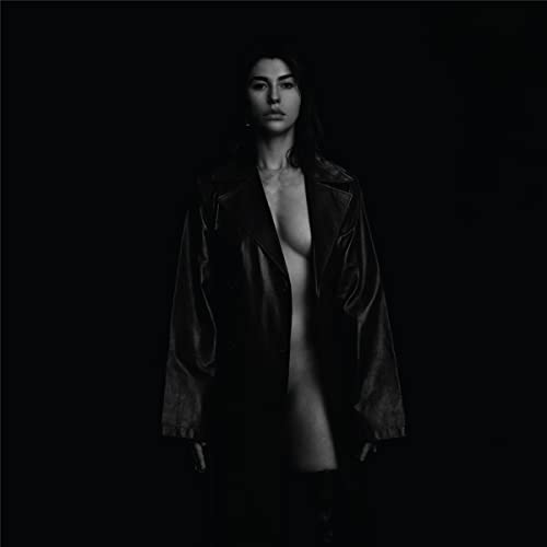 Black and white portrait of Kimbra in a leather jacket.