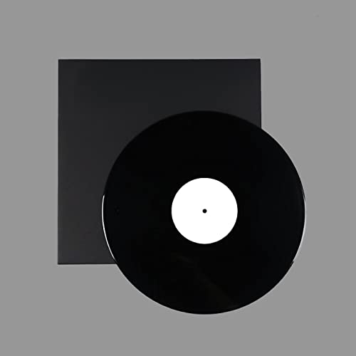Black vinyl record with white center label, against a dark background.