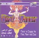 "CD cover art featuring a dancer in a vibrant, ornate costume on a purple background."