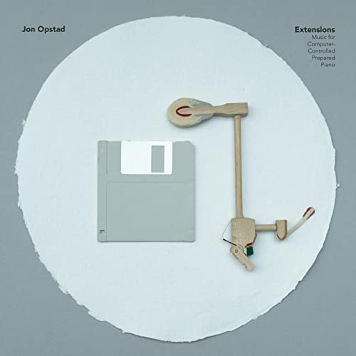CD cover: floppy disk, wooden tool, and white circular background.