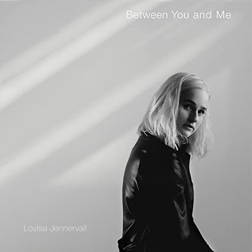 CD cover: Portrait of a blonde woman in black, with text.