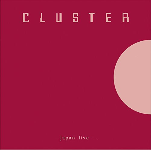 "Red album cover with 'CLUSTER' in white text and a pink circle."