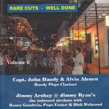 A CD cover featuring a crowded street scene at night with blue and yellow text.