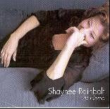 CD cover featuring a woman lying on a couch, wearing a black dress, with artist's name.