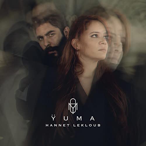 CD cover featuring a man and woman with blurred, ghostly figures.
