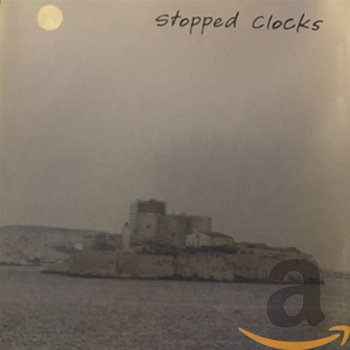 CD cover for “Stopped Clocks” featuring a coastal landscape with a castle.