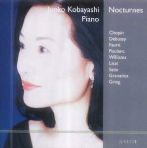 CD cover featuring a woman with dark hair and red lips against a blue background.