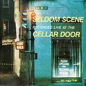 Album cover for "Seldom Scene Live at the Cellar Door" with urban street scene.