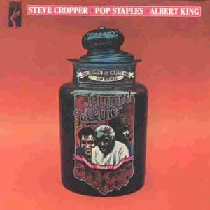 Album cover featuring a black jar against a red background with three musicians' portraits.