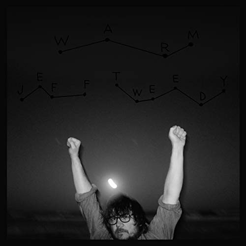 Black-and-white album cover with a man raising fists and constellations spelling "JEFF TWEEDY WARM".