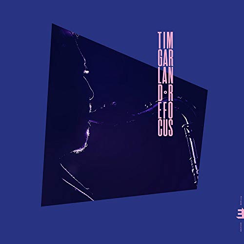 Vinyl album cover with a tilted, dark blue image of a saxophonist on a blue background.
