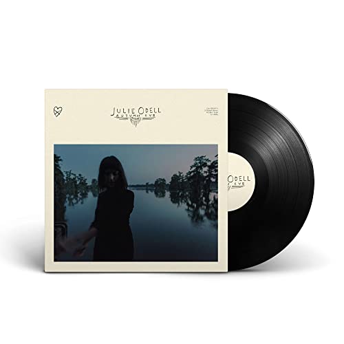 Vinyl record cover and disc featuring a woman standing by a dark, reflective lake.