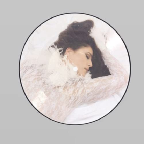 Jessie Ware album cover: woman in white lace, eyes closed, circular frame.