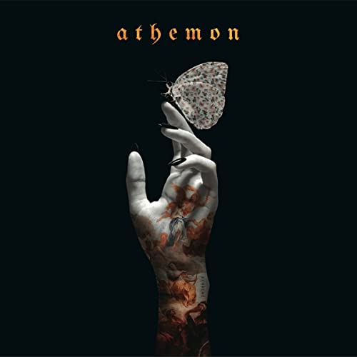 CD cover: hand holding a butterfly against a dark, ornate background.
