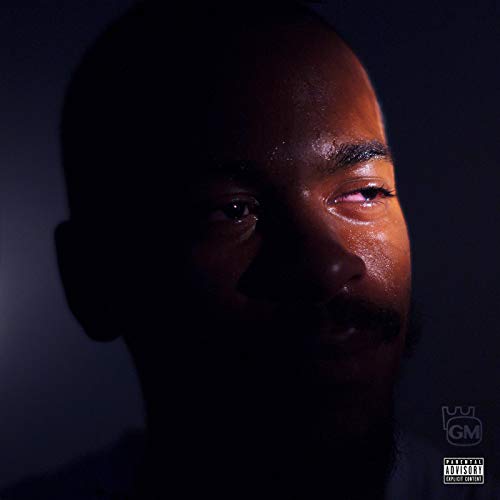 Close-up portrait of a Black man with closed eyes, dark background.
