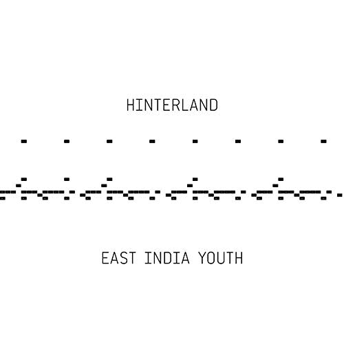 Album cover for East India Youth's "Hinterland" with abstract white design.