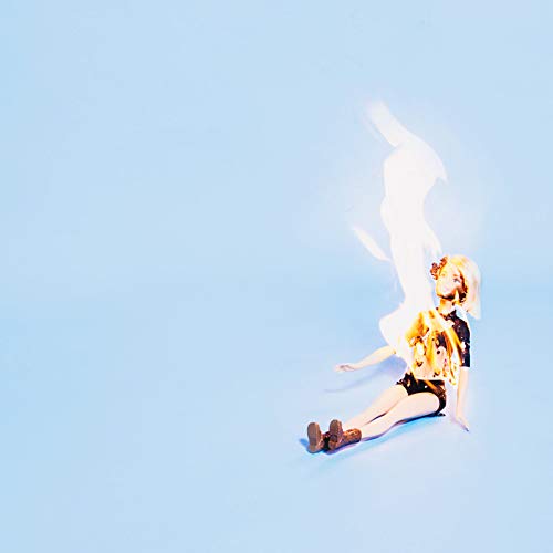 A blonde-haired anime figurine sits on a light blue background, engulfed in flames.