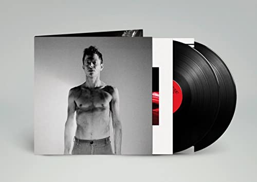 Vinyl record and album cover featuring a shirtless man in grayscale.