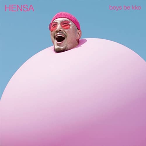 Man with pink hat and sunglasses floats within a pink sphere.