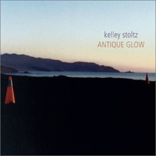 Album cover for Kelley Stoltz's "Antique Glow" with a coastal landscape.