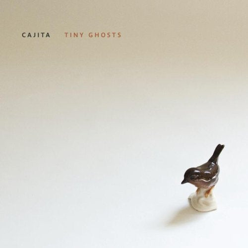 "Album cover with a small ceramic bird figurine on a white background."