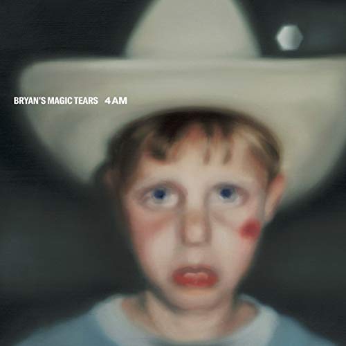 "Album cover featuring a young boy wearing a white cowboy hat, with a surprised expression."