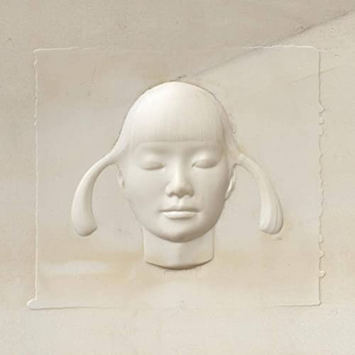 White plaster cast of a young girl’s face with pigtails.