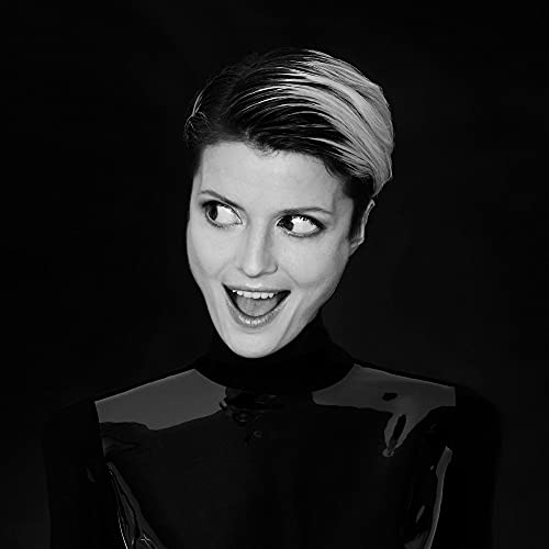 Black and white portrait of Olga Bell, smiling and looking upwards.