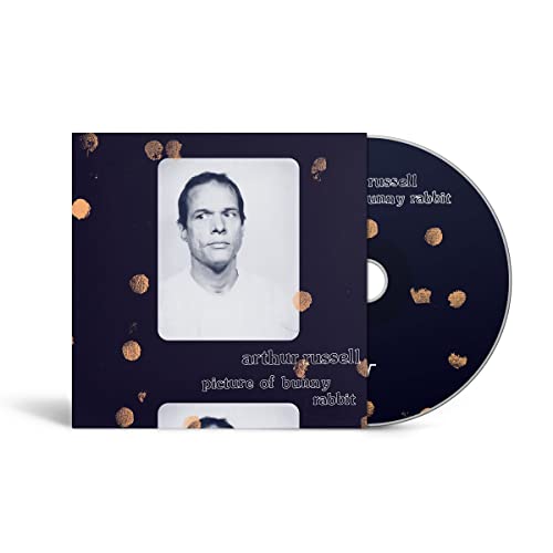 CD case featuring a black background with a portrait and gold dots.