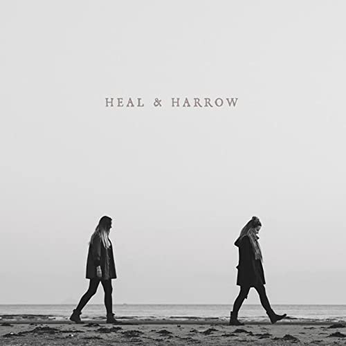 Black and white album cover featuring two women walking on a beach.