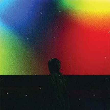 CD cover with a silhouetted figure against a colorful, blurred background.