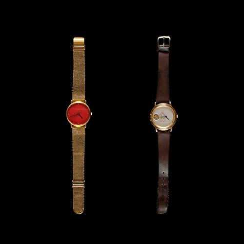 Two gold watches, one with red face and gold band, the other with white face and brown leather band.
