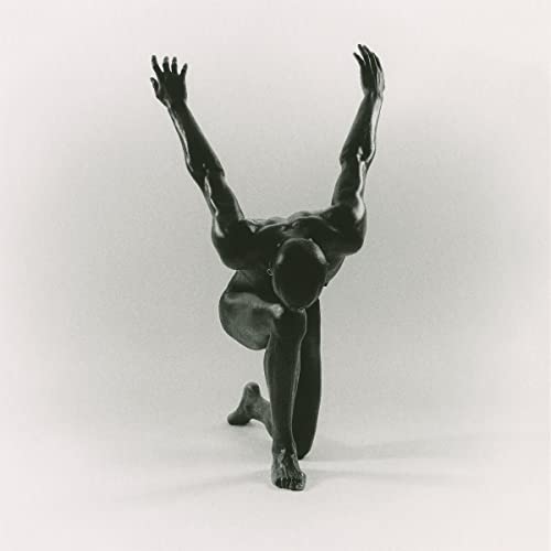 BlackHCCSB&W photo of a dark, muscular figure kneeling with arms raised against white background.