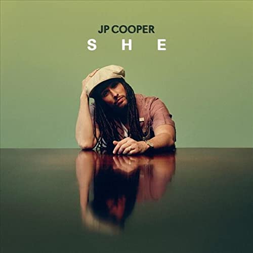JP Cooper album cover, portrait of artist with dreadlocks and cap.