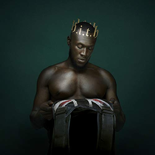 "Man wearing a crown, holding a jacket with a Union Jack design."