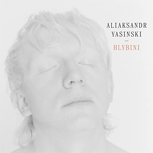 Close-up portrait of a man with eyes closed, album cover art.